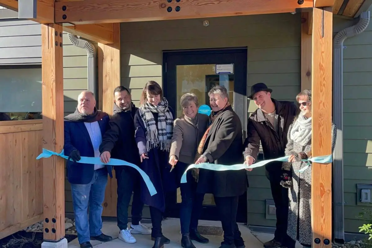 From the AVNews article linked... a line of people stand in front of the doors of a building as a ribbon is cut.